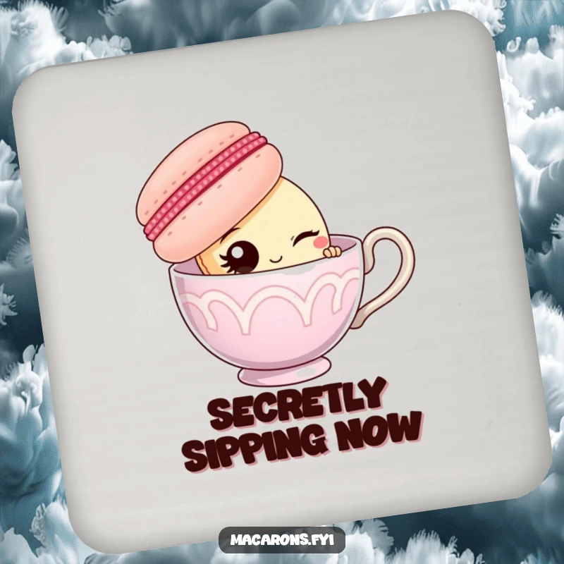 Funny macaron character peeking from behind a giant teacup, offering a wink, on a decorative drink coaster.
