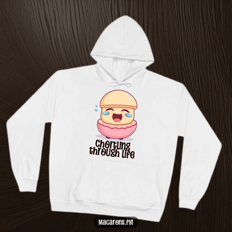 Funny macaron character laughing heartily with little joyful tears escaping, featured on a warm and cozy hoodie.