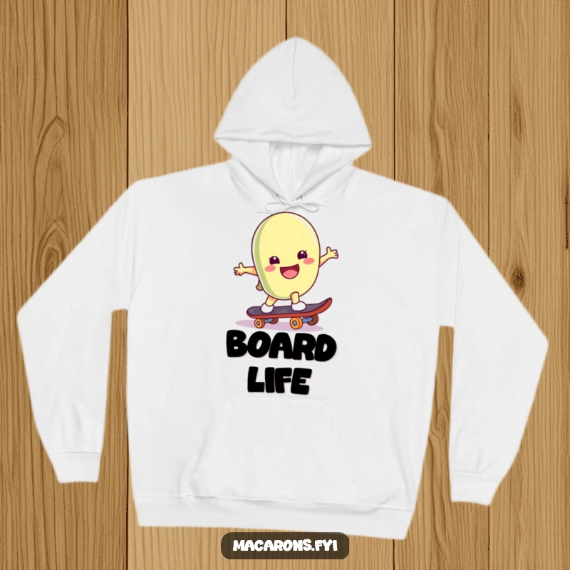 Funny macaron character on a skateboard, doing a trick with a big smile, featured on a soft hoodie.