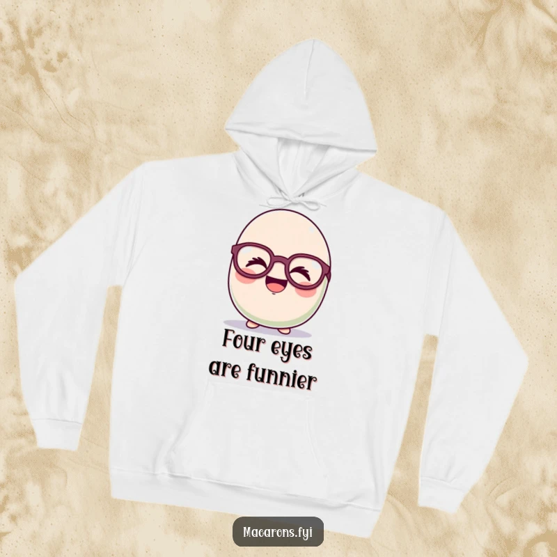 Warm funny macaron character giggling hysterically behind oversized, comical glasses, featured on a plush hoodie for cozy fun.