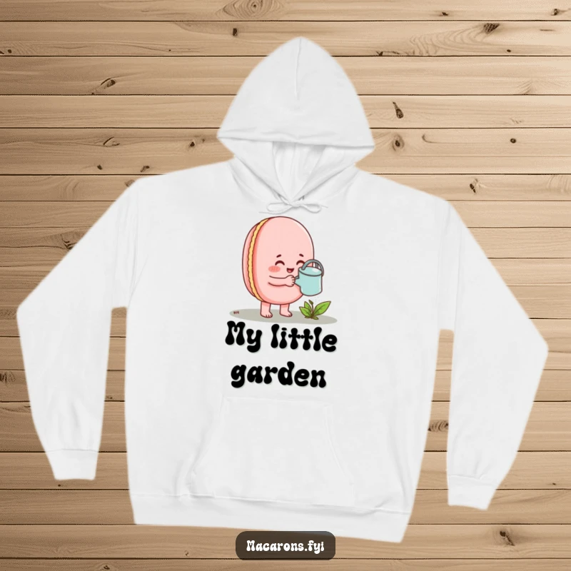 Funny Macaron Hoodie depicting an enthusiastic macaron watering a tiny sprout with a small watering can.