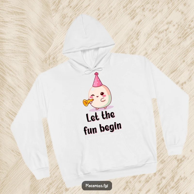 Funny Macaron Hoodie: Festive Kawaii macaron character wearing a party hat, happily tooting a tiny trumpet, radiating celebration.