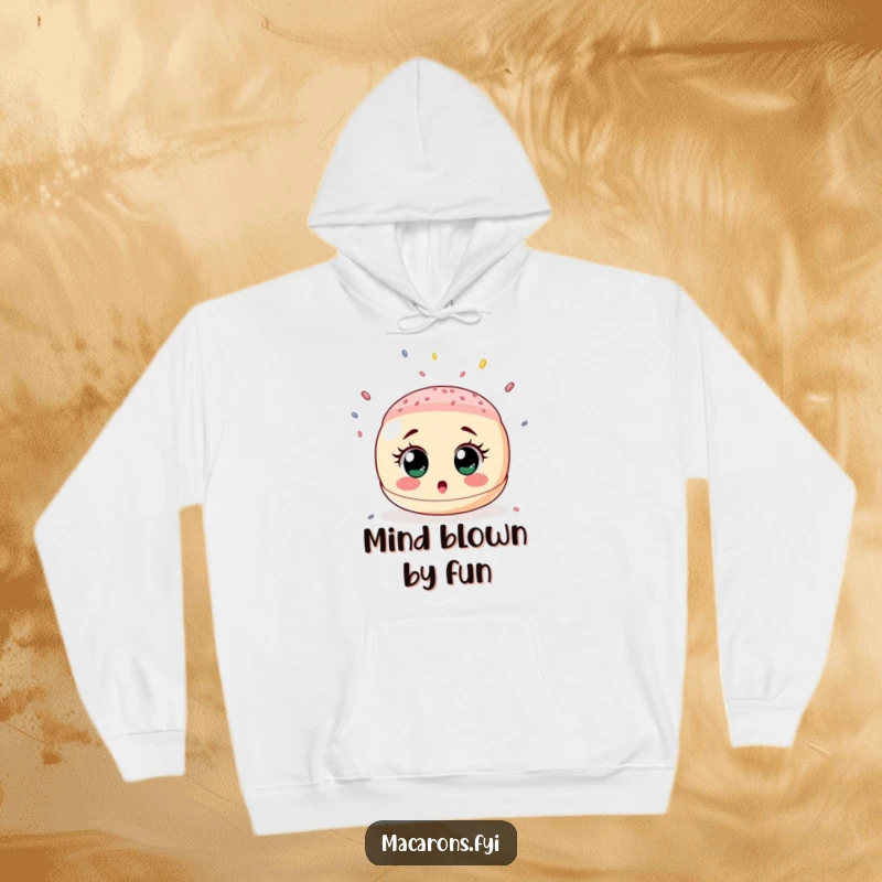 Funny hoodie depicting a wide-eyed, surprised macaron caught under a whimsical shower of tiny, colorful sprinkles, radiating playful shock.