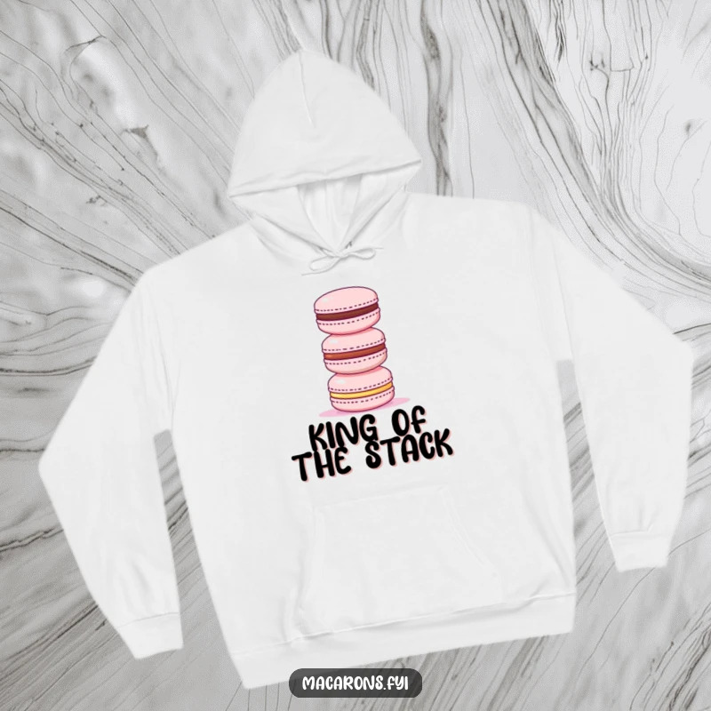 Funny hoodie featuring a triumphant macaron standing tall atop a stack of three smaller macarons, a symbol of sweet domination.