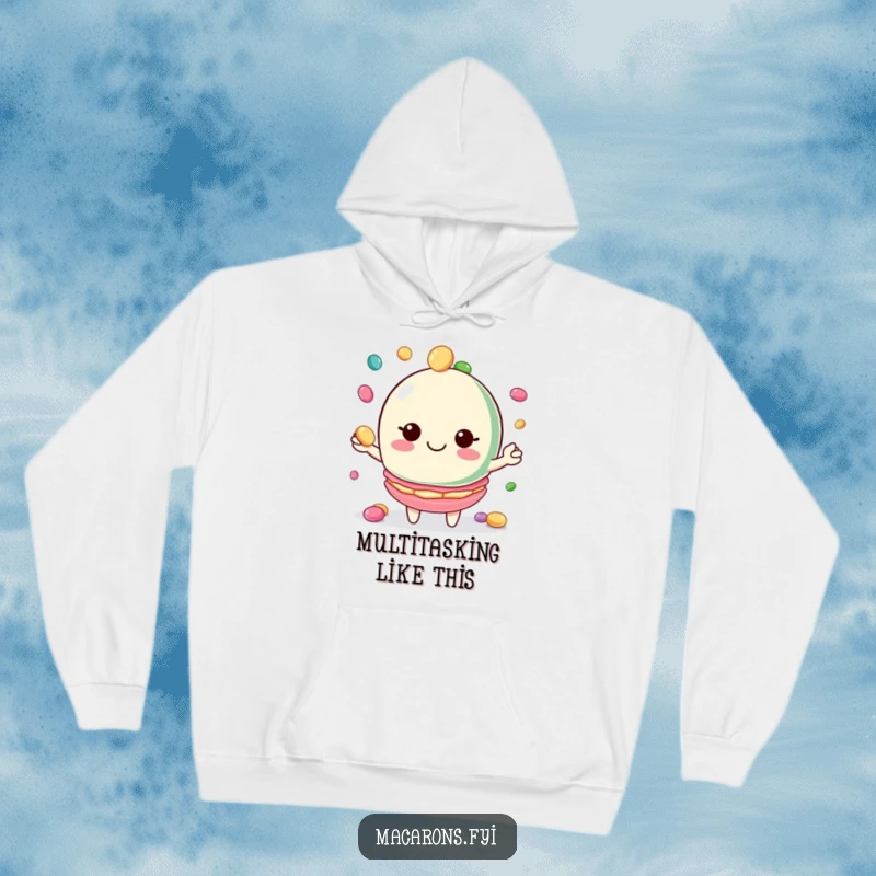 Funny macaron hoodie featuring a macaron character juggling candies with a big smile, cozy and cheerful.