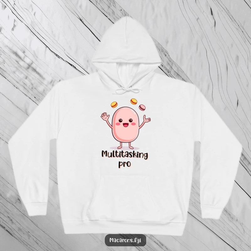 Funny cheerful macaron character juggling multiple macarons, featured on a soft and warm hoodie.