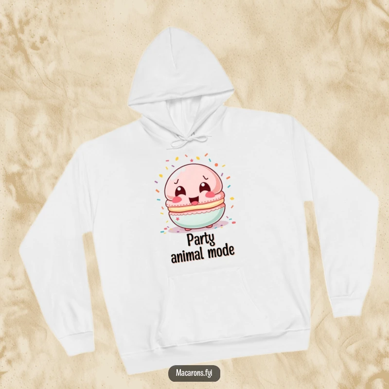 Funny macaron character laughing heartily, showered by a cascade of colorful confetti, featured on a soft hoodie.