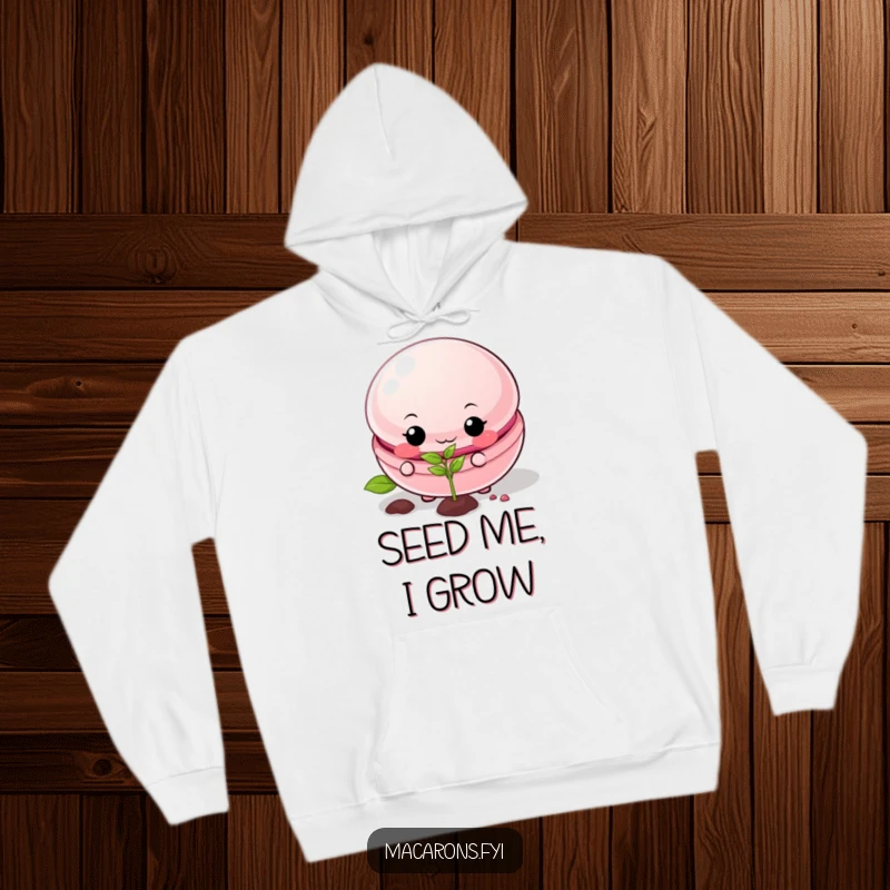 Funny macaron hoodie featuring a mischievous macaron planting a tiny seed, offering warmth and humor.