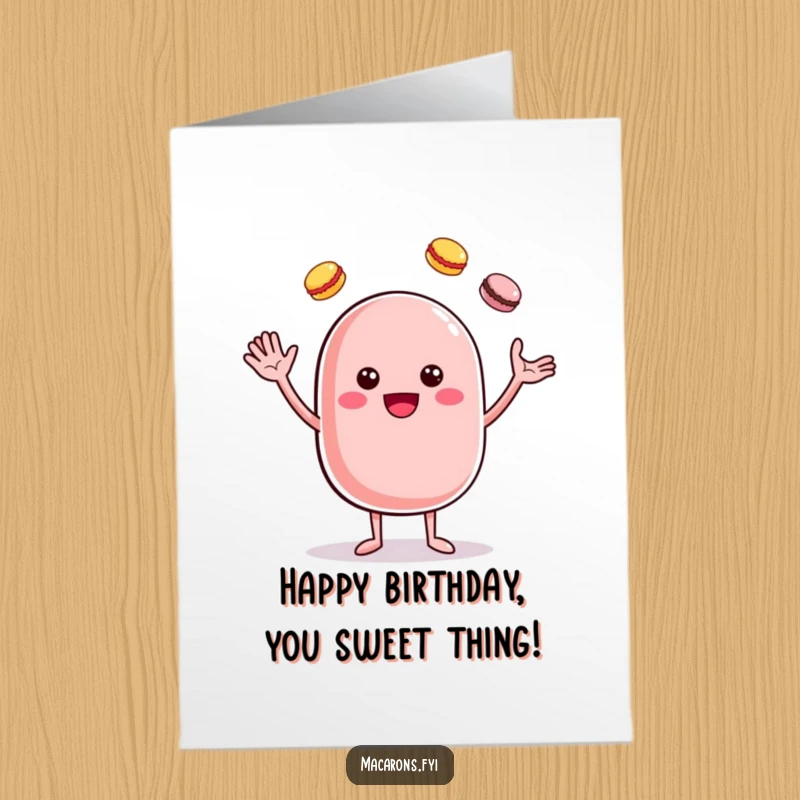 Funny Free Printable Birthday Card: A cheerful macaron character waves hello while expertly juggling smaller, colorful macarons, celebrating your special day.