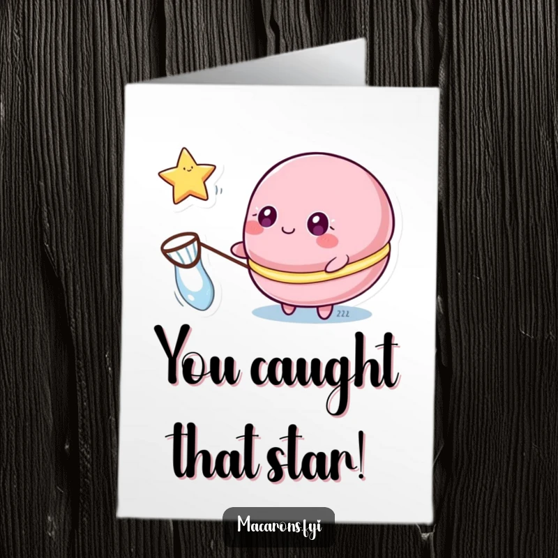 Funny free printable congratulations card showing a macaron character with sparkling eyes, catching a floating star with a net.