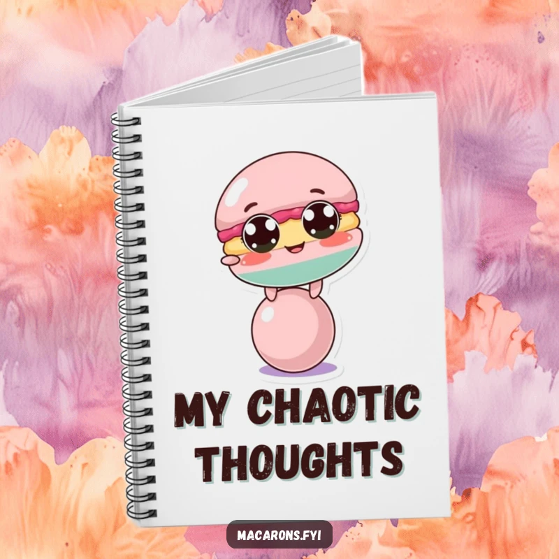 Funny macaron character comically trying to balance on a small ball, featured on the cover of a funny notebook.