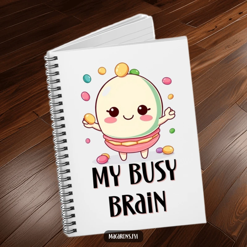 Funny macaron notebook with a smiling macaron character juggling candies, ideal for notes and doodles.