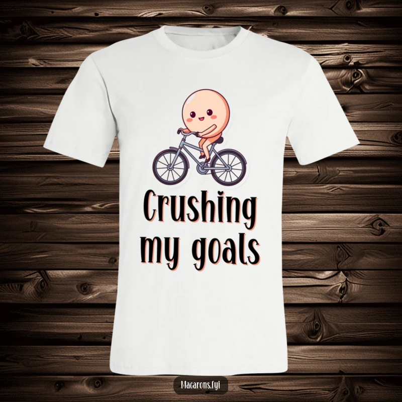 Funny macaron character on a tiny bicycle, pedaling with a determined and happy face, featured on this comfortable graphic tee.