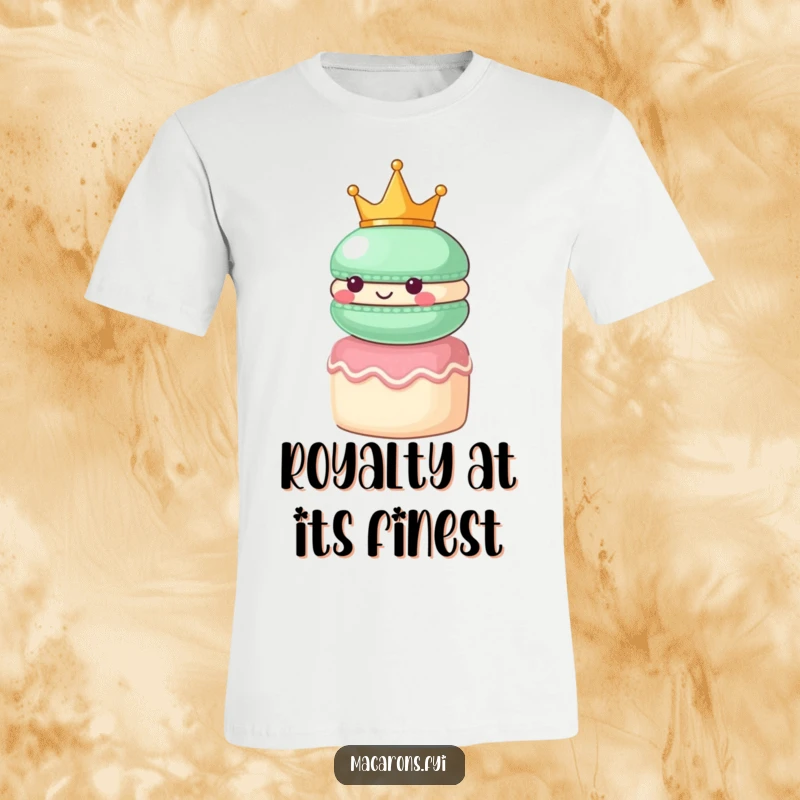 Funny macaron character wearing a small crown, looking regal atop a tiny cake, printed on a stylish t-shirt.