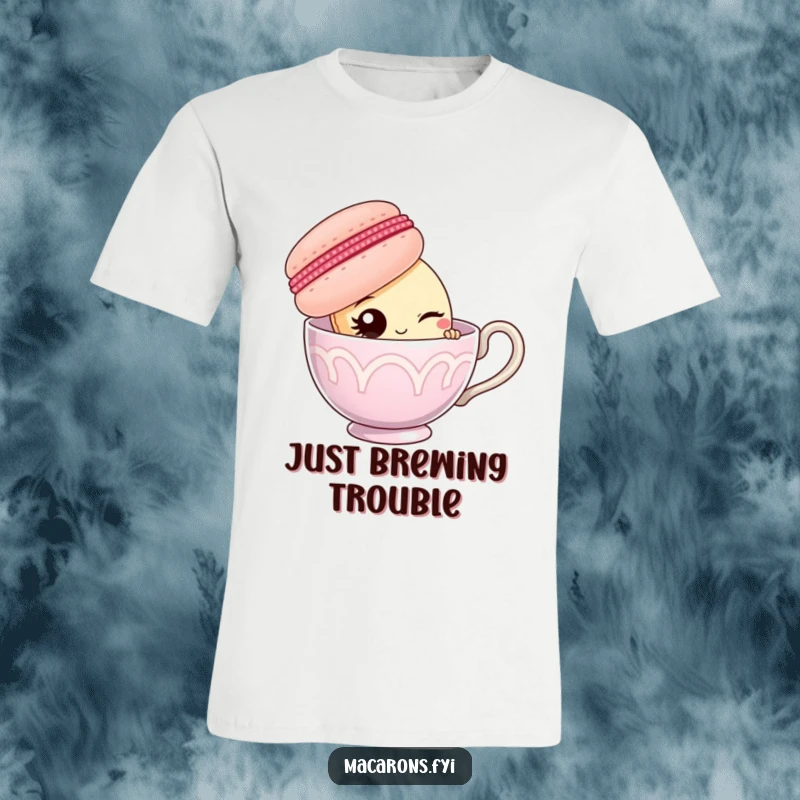 Funny macaron character peeking from behind a large teacup and winking, printed on a comfortable t-shirt.