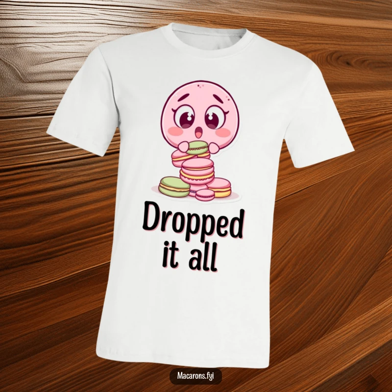 Funny surprised macaron character with wide eyes, dropping a stack of macarons, printed on a t-shirt.