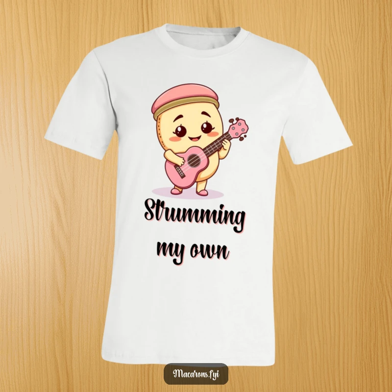 Funny macaron character with a goofy grin playing a miniature ukulele with passion, printed on a fun t-shirt.