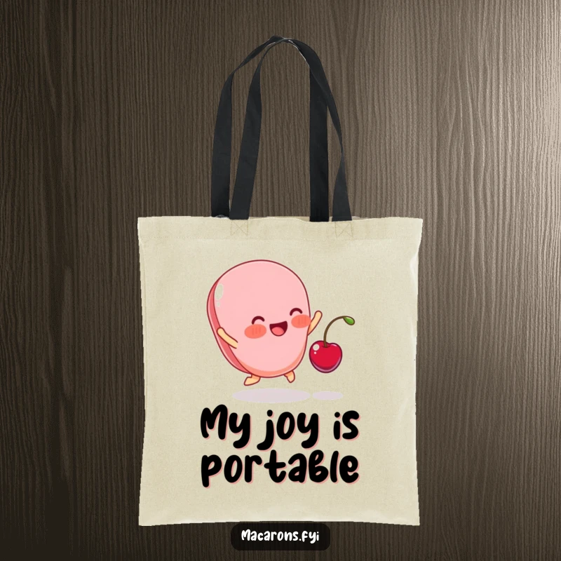 Funny tote bag illustrating a blushing macaron leaping for joy as a tiny cherry lands on it, a symbol of sweet happiness.