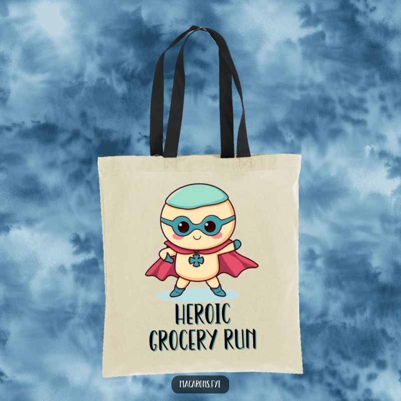Funny superhero macaron tote bag with a macaron in a dramatic pose and flowing capes, a heroic accessory.